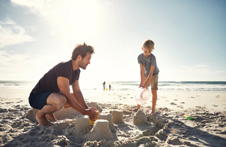 Dad on the beach with son