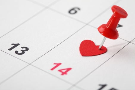 A close-up of a calendar with a heart pinning on February 14